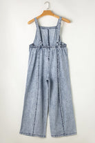 Casual chic wide leg overalls from Thread Bar Boutique in light wash denim with unique reverse seams and playful frayed detailing flat lay rear
