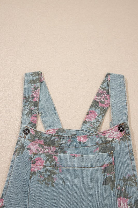 Pink and sage floral print denim overalls from Thread Bar Boutique with pleated detailing and relaxed wide leg silhouette.