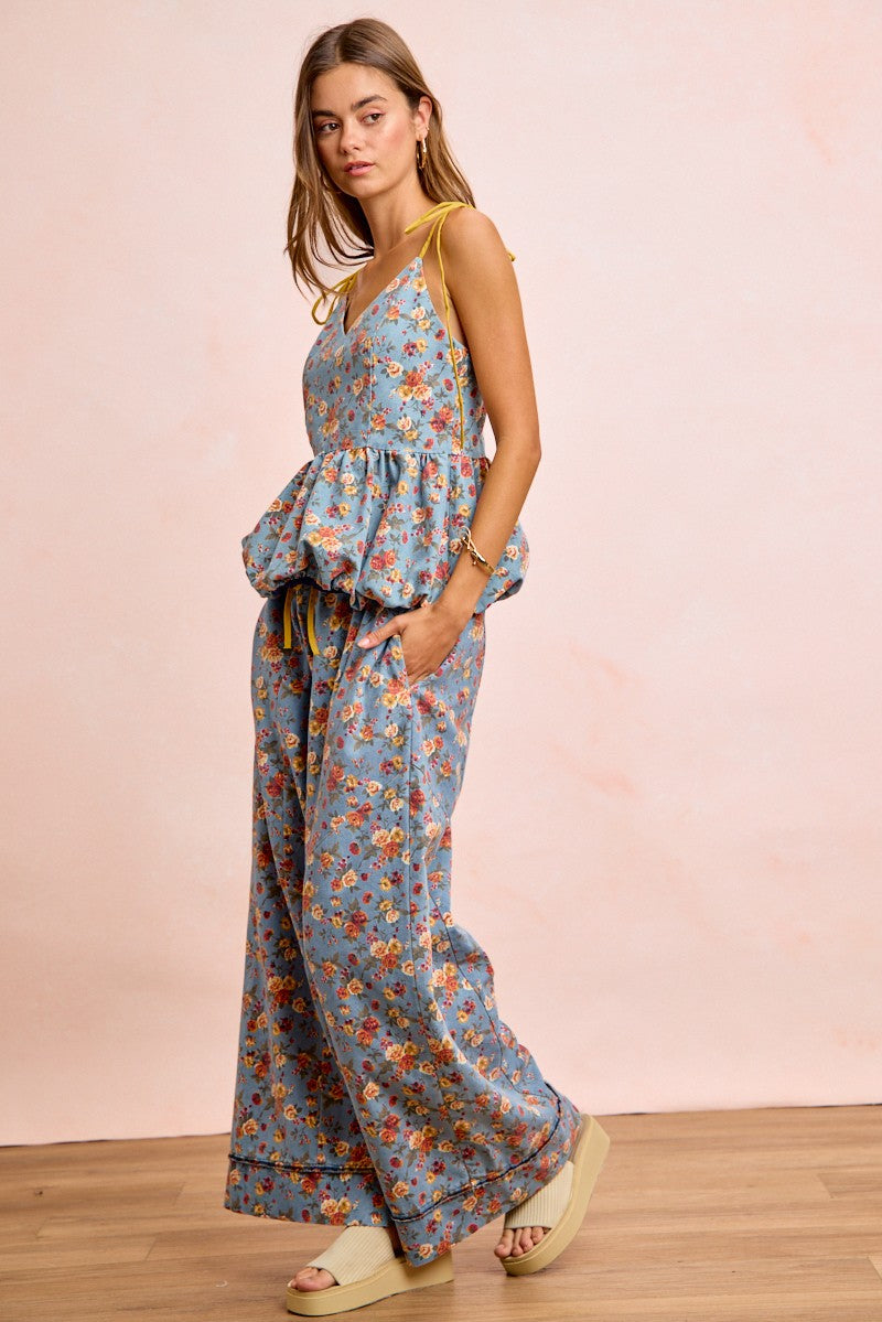 Close-up detail of vibrant floral print on cotton blend wide leg pants in dusty blu