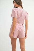 Two-piece outfit featuring a crochet lace crop top and matching high-waisted shorts, styled for a soft and feminine summer look.

