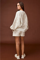 Camo high-waisted drawstring shorts, part of a coordinated camo sweat set with a matching crewneck