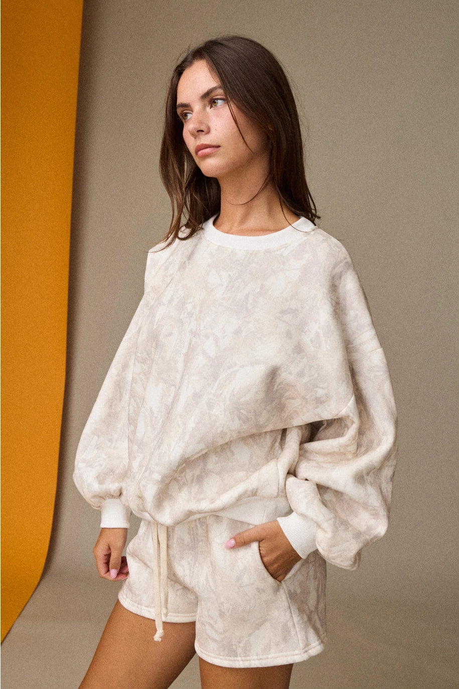 Woodland camo oversized crewneck sweatshirt, part of a matching camo sweat set with coordinating shorts.”