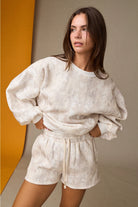 Camo high-waisted drawstring shorts, part of a coordinated camo sweat set with a matching crewneck