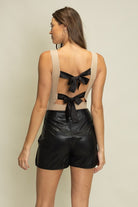 Butter soft faux leather tulip skort with bow tie detail and built-in shorts for women from Thread Bar Boutique