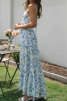 Floral halter midi dress from Thread Bar Boutique featuring ruched front, open tie back, and flowy feminine silhouette