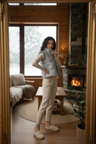 Person taking a mirror selfie in a cozy living room with a fireplace.