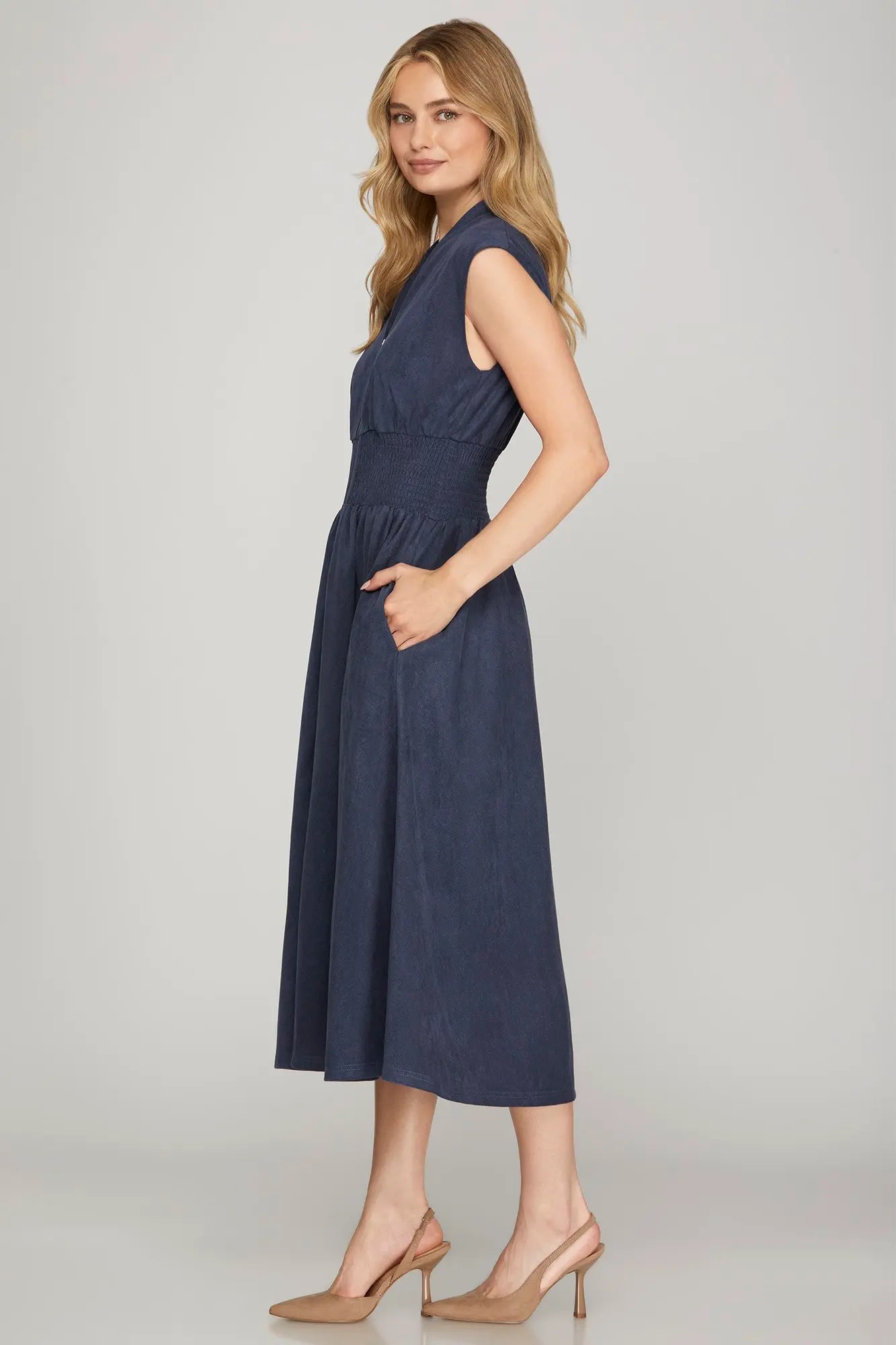 Elegant suede midi dress with front zip closure, stretchy smocked waist, relaxed drop shoulder design, cap sleeves, and pockets, offering polished comfort for fall events, work, and everyday wear.