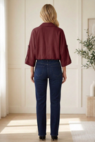 burgundy utility jacket showing collared neckline, 3/4 button-tab sleeves and waist-length hem.
