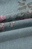 Pink and sage floral print denim overalls from Thread Bar Boutique with pleated detailing and relaxed wide leg silhouette. Fabric close up