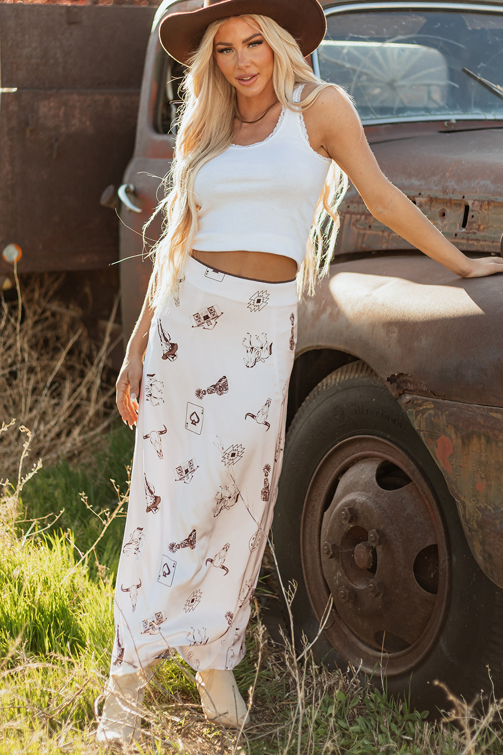 woman wearing a cream satin maxi skirt with western inspired print