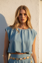 Close-up - teal cap-sleeve crop top