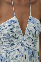 close up Feminine floral halter midi dress from Thread Bar Boutique with ruched detailing and adjustable tie back closure