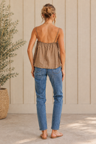 Back view of mocha floral lace cotton flare cami with adjustable straps and neutral sandals