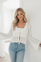 Women’s off white cardigan with ribbed knit texture and ribbon closure