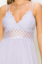 Model wearing an elegant lace maxi dress with a bustier-style bodice and flowing skirt, styled for a romantic formal occasion.