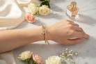 Double Clover Cubic Zirconia Bangle flatlay on marble with flowers