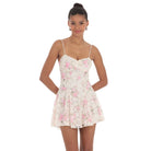 A model wearing a floral lace mini dress with a sweetheart neckline, adjustable spaghetti straps, and a skater-style silhouette. The dress is fully lined, and features delicate lace fabric, perfect for a feminine and trendy look.