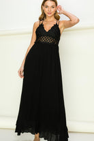Model wearing an elegant lace maxi dress with a bustier-style bodice and flowing skirt, styled for a romantic formal occasion.
