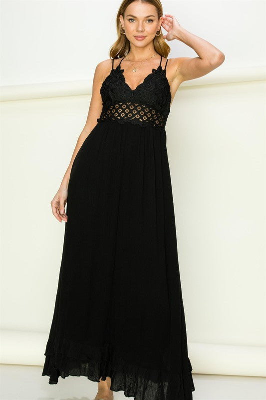 Model wearing an elegant lace maxi dress with a bustier-style bodice and flowing skirt, styled for a romantic formal occasion.