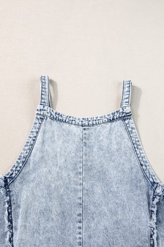 Casual chic wide leg overalls from Thread Bar Boutique in light wash denim with unique reverse seams and playful frayed detailing flat lay