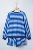 Blue and white striped dress on a wooden hanger against a white background