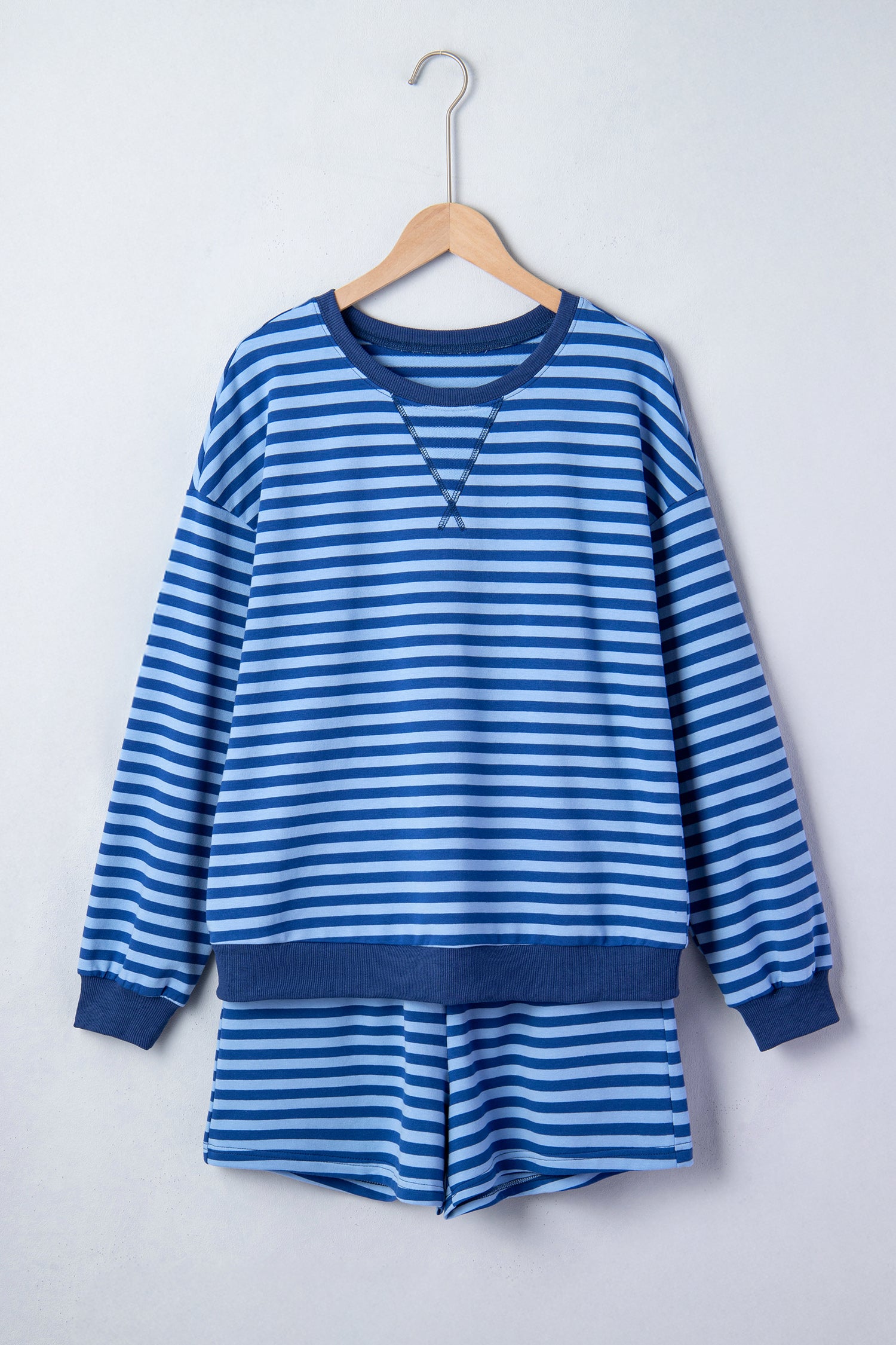 Blue striped lounge short set from Thread Bar Boutique with breathable cotton blend, long sleeve top, and pull-on shorts flat lay front