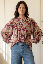 Floral blouse hands-on-hips pose