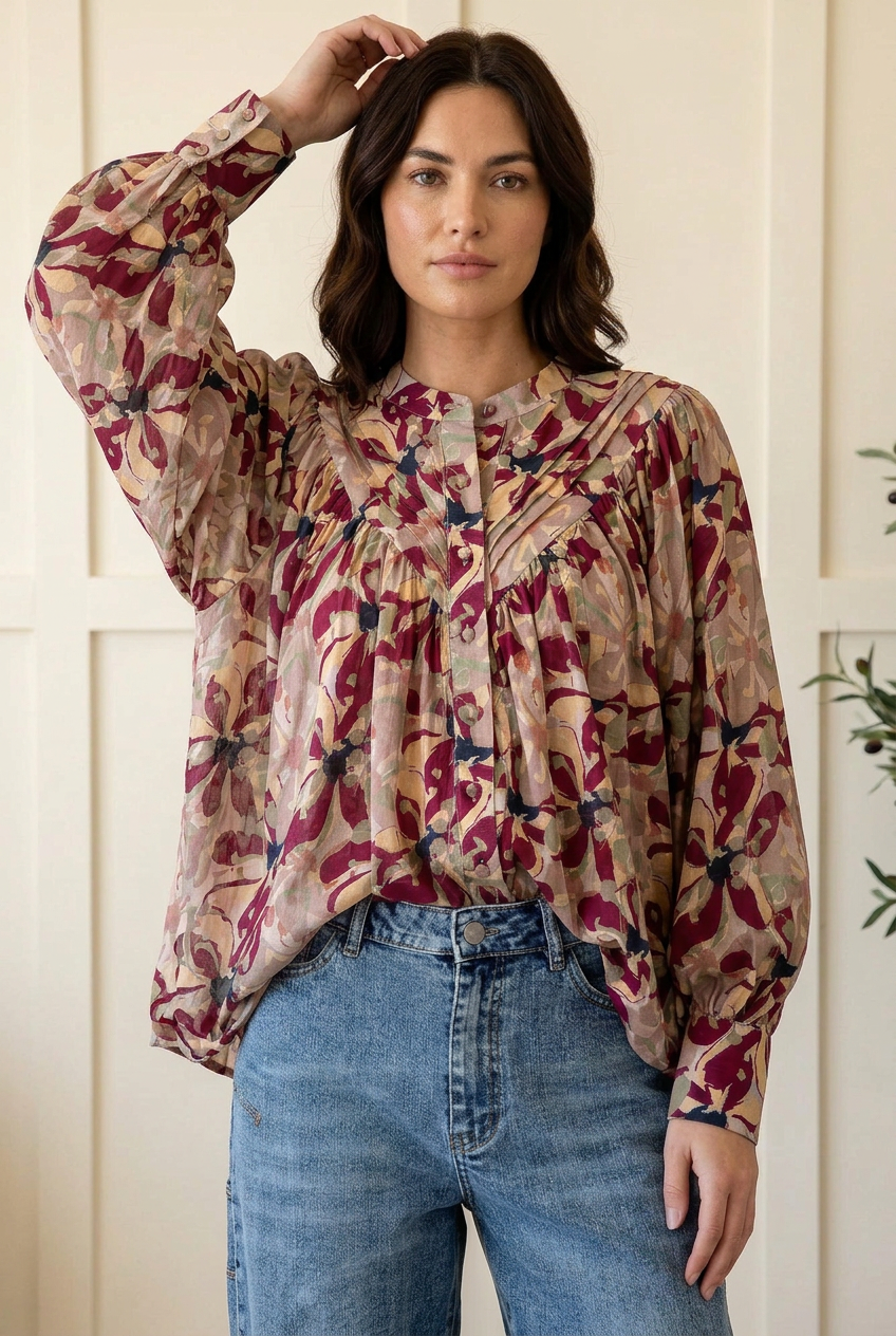 Floral blouse raised-arm pose showing balloon sleeves