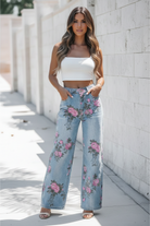 Sky blue garden floral bootcut jeans front view showing all-over pink floral print, wide-leg silhouette, low rise, and front pockets