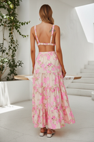 Back view of pink multicolor floral print two-piece set showing open back strap detail and tiered maxi skirt — Thread Bar Boutique