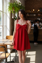 Vibrant red A-line mini dress with bow tie shoulders and lightweight cotton blend, perfect game day outfit from Thread Bar Boutique