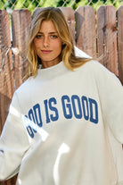 Reversible faith sweatshirt with Jesus and God Is Good text in ash grey and vintage blue letters