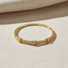 Stackable stainless steel bangle bracelet with crystal detailing and modern design