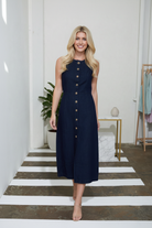 Sleeveless denim midi dress with button down front and round neckline, versatile women’s dress for casual or dressed up looks