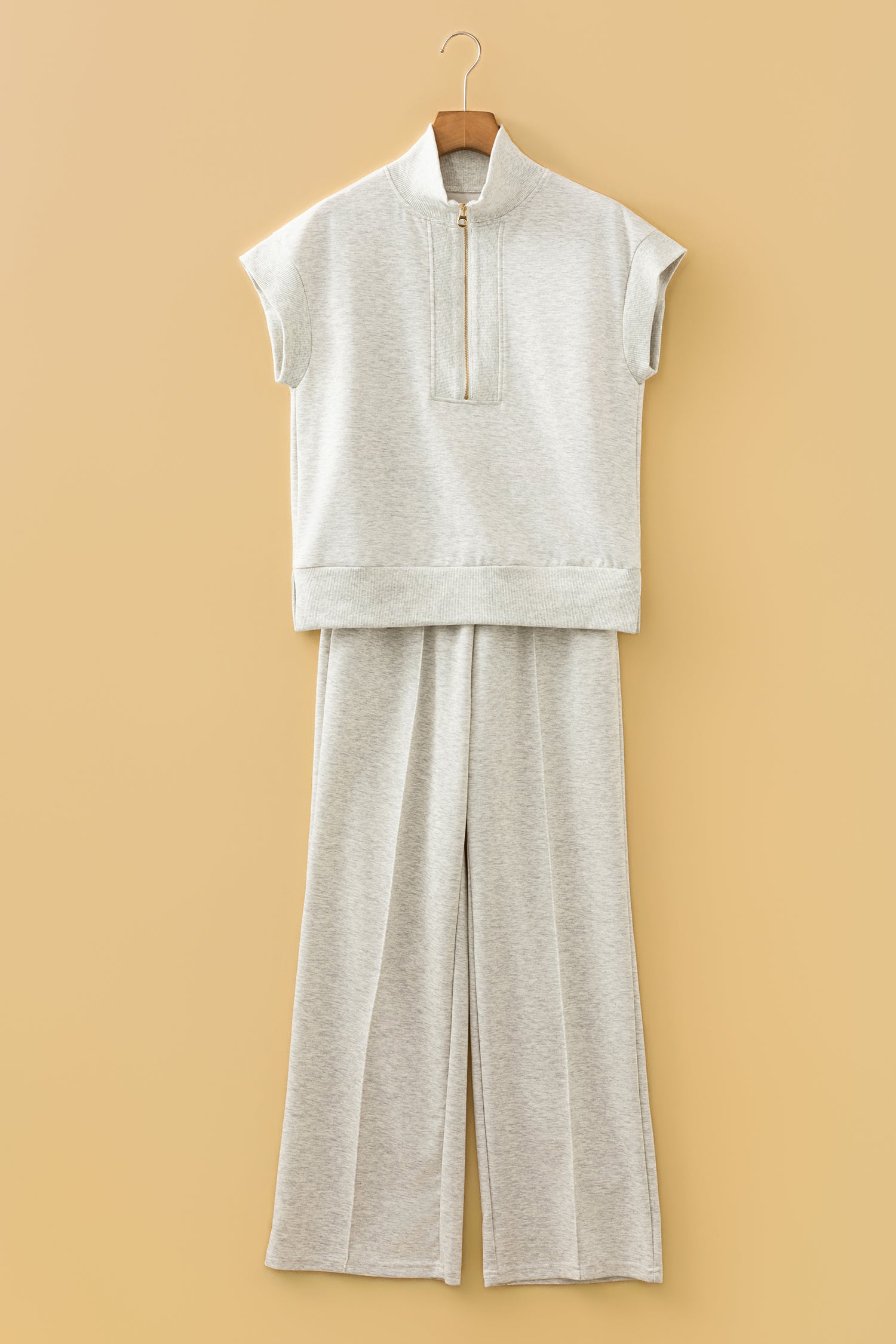 Flat lay of grey half zip polo tee and coordinating pants set