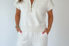 Close-up of half zip polo neckline on light grey lounge set with soft stretch fabric