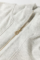 Detail shot of zipper collar and fabric texture on light grey two piece set