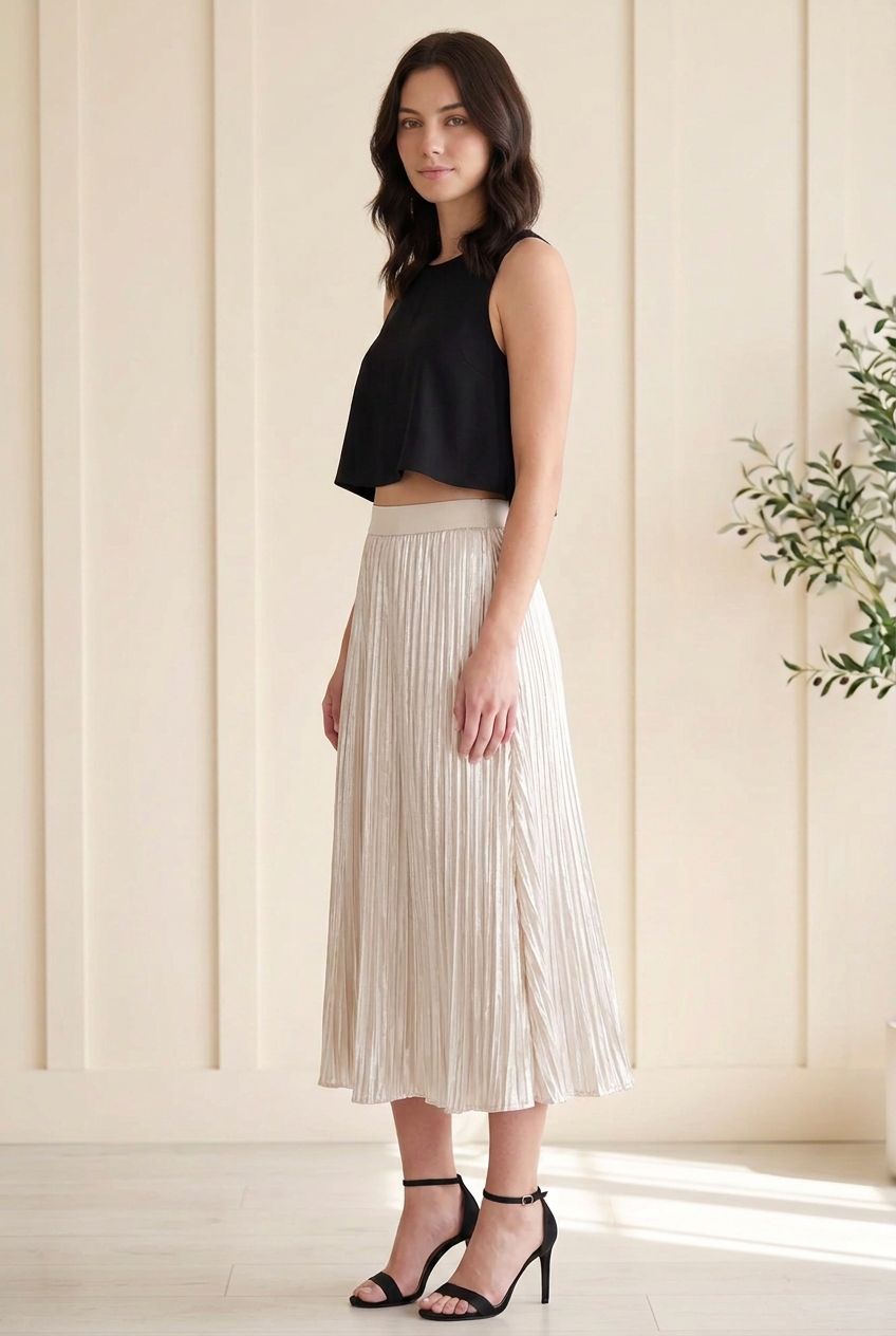 Side view of cream silver metallic midi skirt showing fine pleats, reflective fabric and a flowing hem.