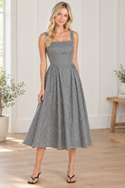 Front view of black and white gingham midi dress with square neckline and wide shoulder straps