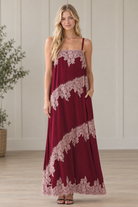 Front view of burgundy contrast floral lace trim maxi dress with square neckline and spaghetti straps
