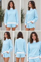Front view of sky blue striped oversized mock neck sweatshirt and matching shorts set with white cuffs and hem