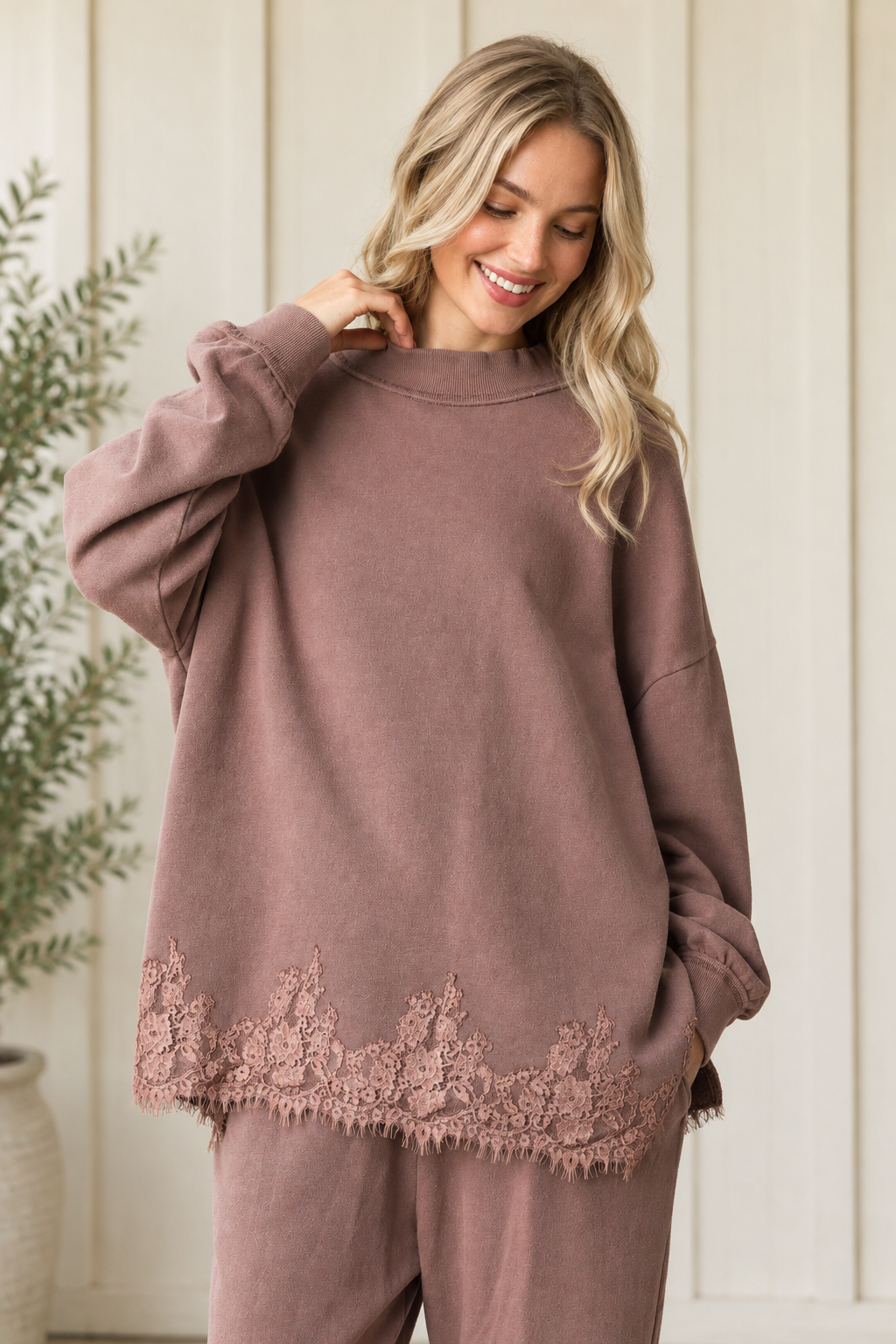 Mauve-brown French terry track pants paired with a matching relaxed sweatshirt featuring a floral eyelash lace hem.