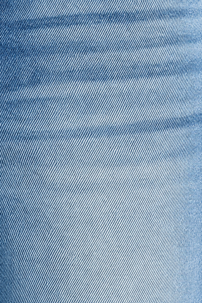 Close-up of medium wash denim showing fabric weave, faded finish and front pocket stitching on barrel jeans