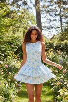 Blue floral active dress with double ruffle skirt in outdoor lifestyle setting