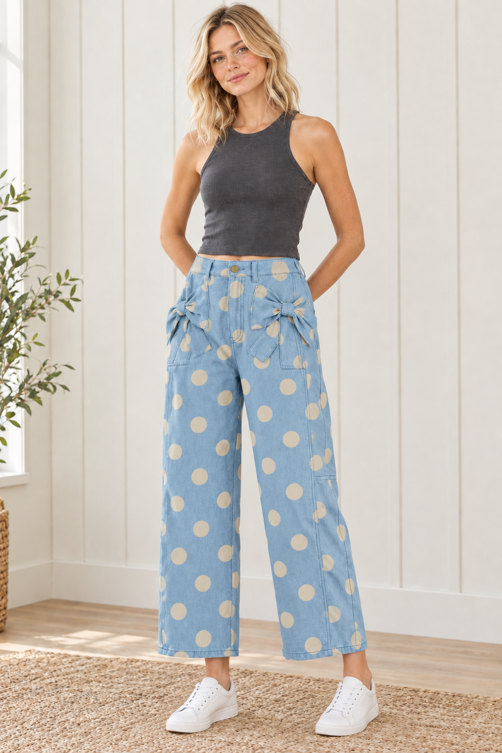 Front view of sky blue polka dot jeans showing matching bows on front pockets, belt loops and roomy legs