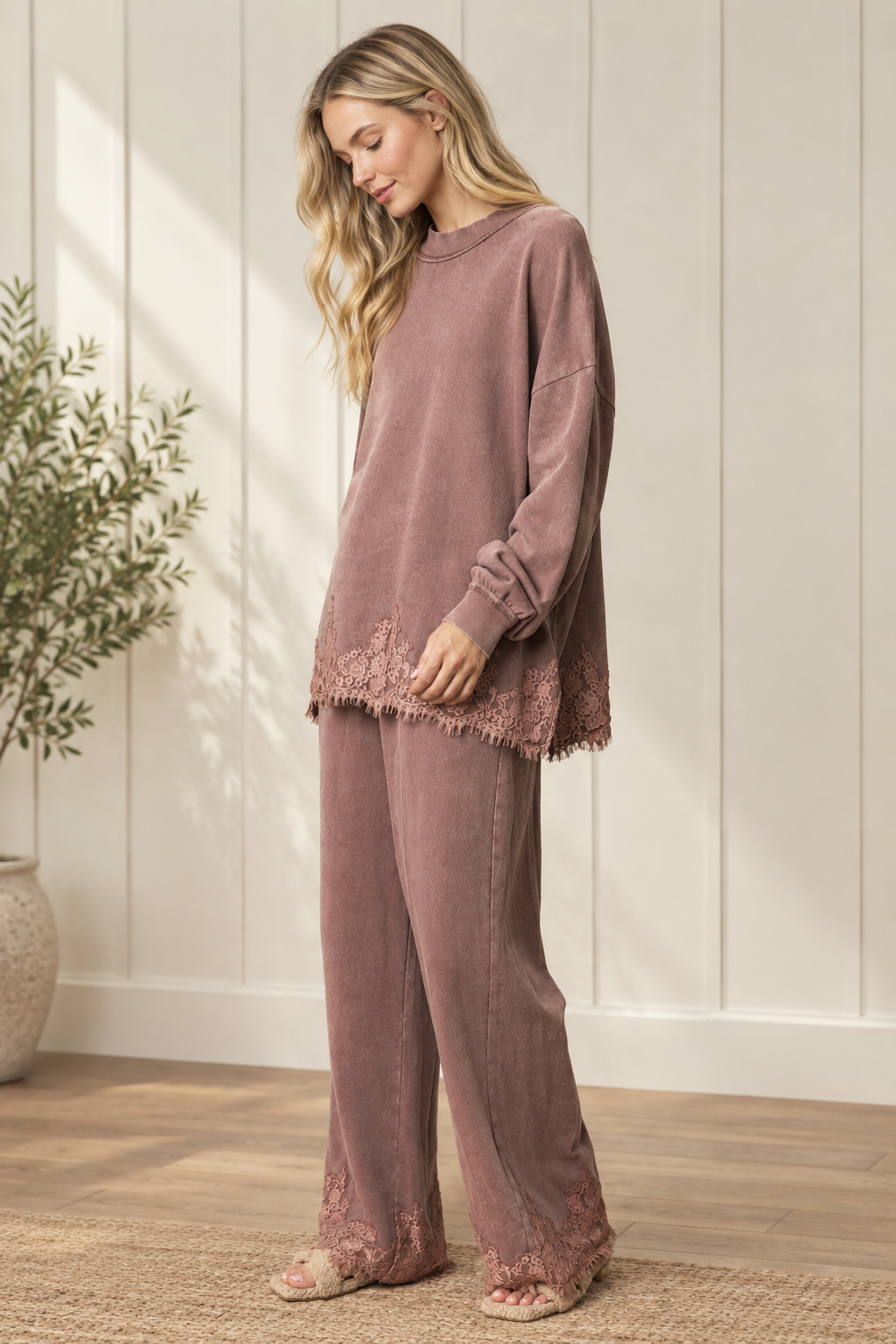 Mauve-brown French terry track pants with wide legs and floral lace hems, worn with the coordinating sweatshirt.