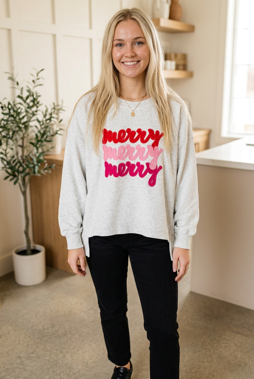 Light grey Merry Christmas sweatshirt with red and pink script lettering, relaxed fit and long sleeves, front view.
