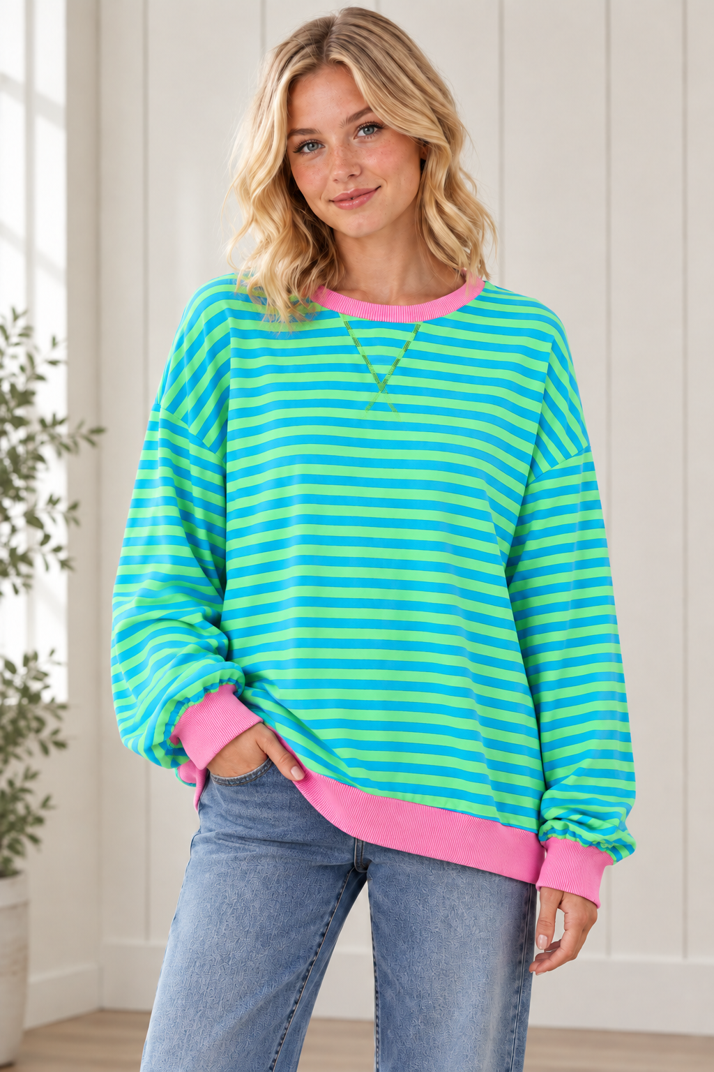 Three quarter view of Casual Cool striped pullover with drop shoulders and pink contrast trim, styled with jeans.