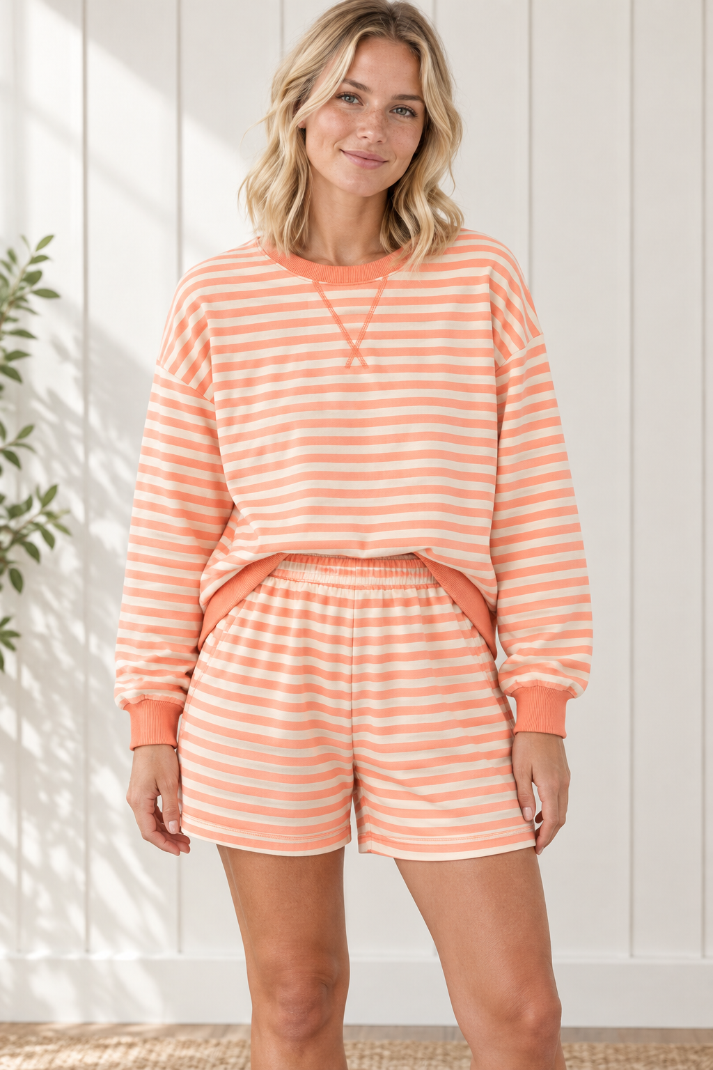 Front view of Grapefruit Orange striped lounge set with relaxed long sleeve pullover and matching elastic-waist shorts