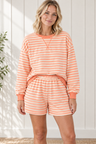 Front view of Grapefruit Orange striped lounge set with relaxed long sleeve pullover and matching elastic-waist shorts